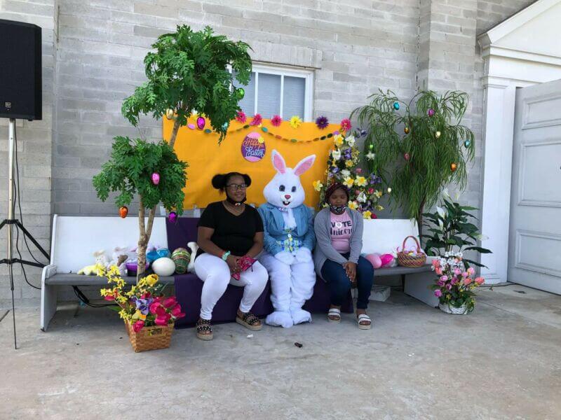 Two kids take a picture with the Easter Bunny at our Easter Egg event